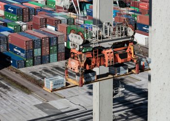 Preparing for CARM Implentation is essential. This image shows a dock moving shipping containers with a crane.