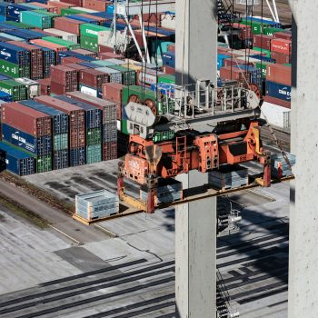 Preparing for CARM Implentation is essential. This image shows a dock moving shipping containers with a crane.