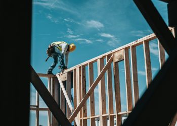 A contractor builds the frame of a building.