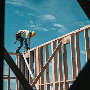 A contractor builds the frame of a building.